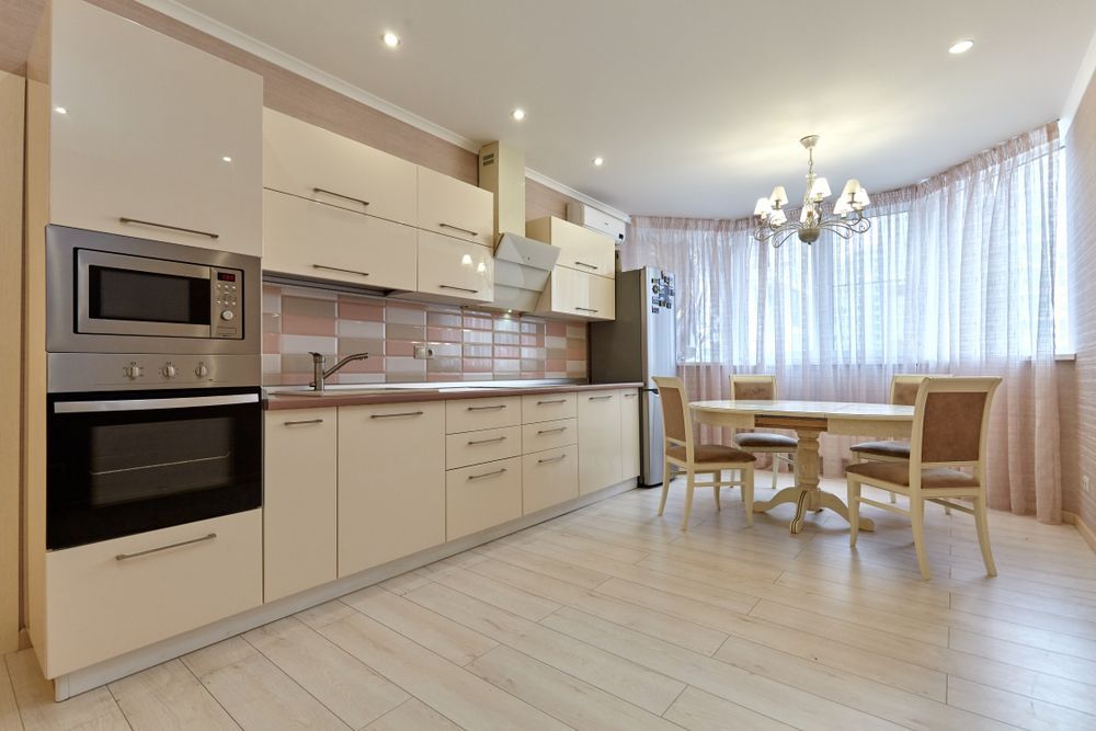 A Kitchen With a Table and Chairs and a Large Window — Hunter Kitchen King In Singleton, NSW