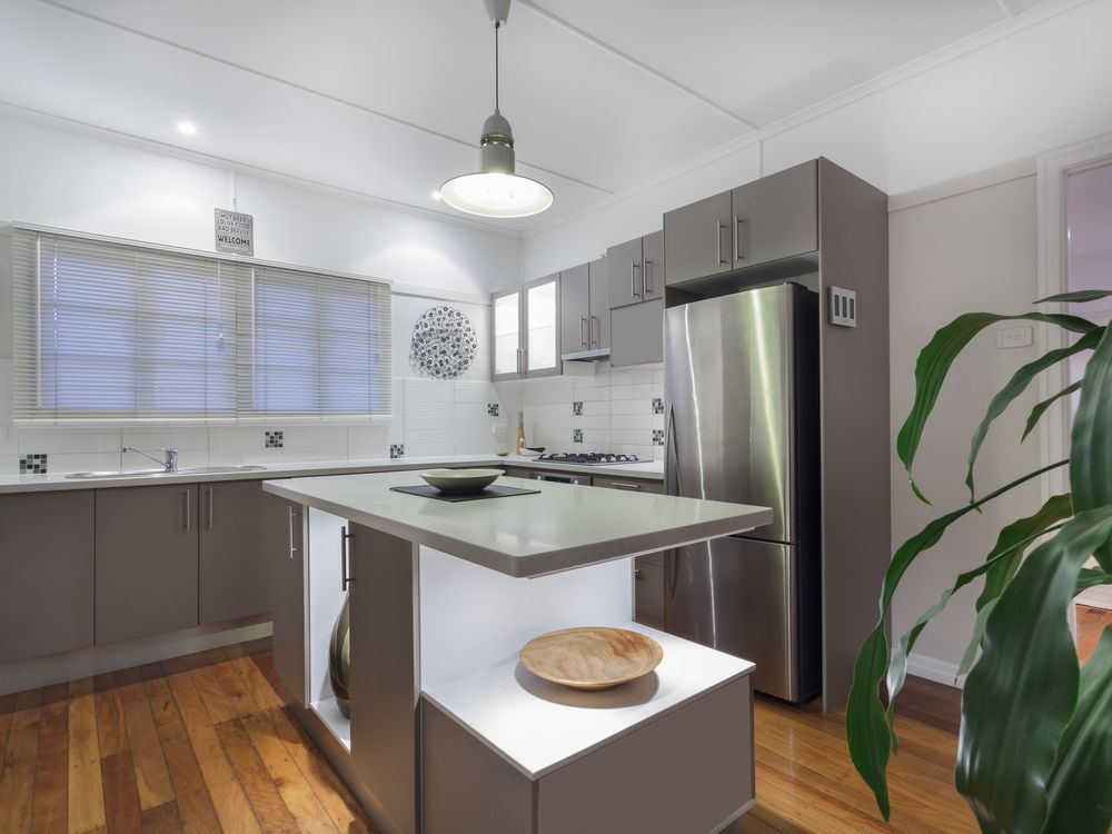 A Kitchen With Stainless Steel Appliances and a Large Island in the Middle — Hunter Kitchen King In Kurri Kurri, NSW