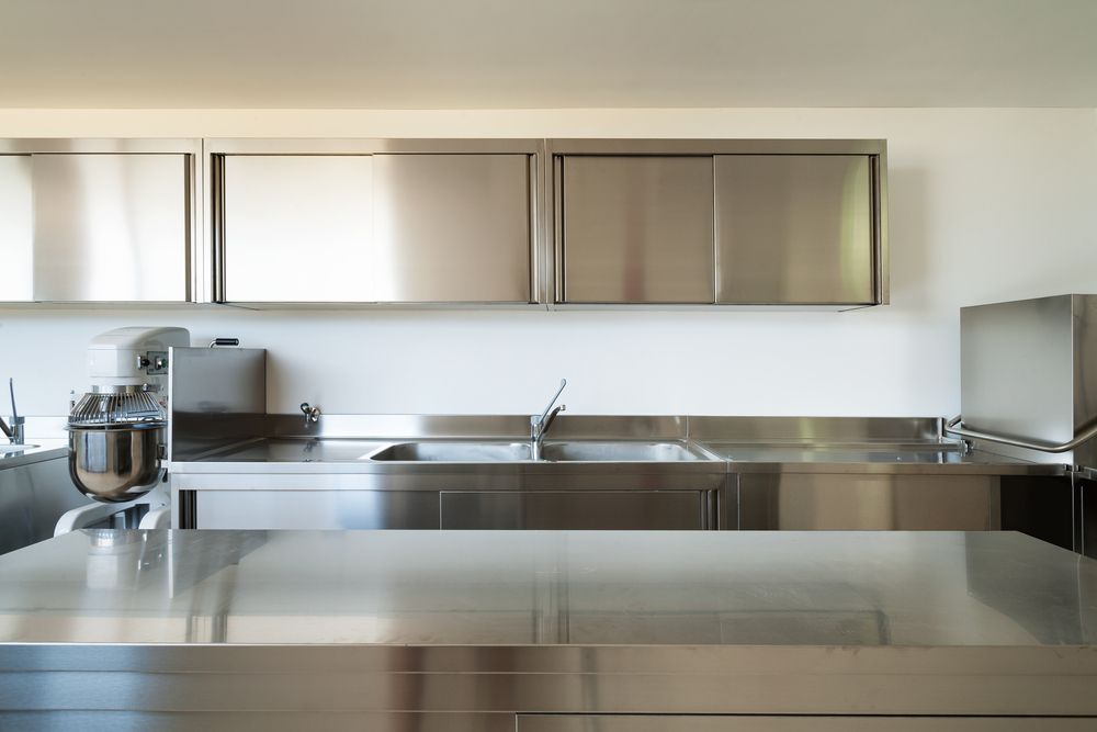 A Kitchen With Stainless Steel Cabinets and Counter Tops — Hunter Kitchen King In Cessnock, NSW
