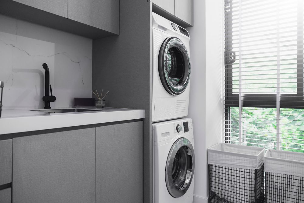 A Laundry Room With a Washer and Dryer Stacked on Top of Each Other — Hunter Kitchen King In Newcastle, NSW
