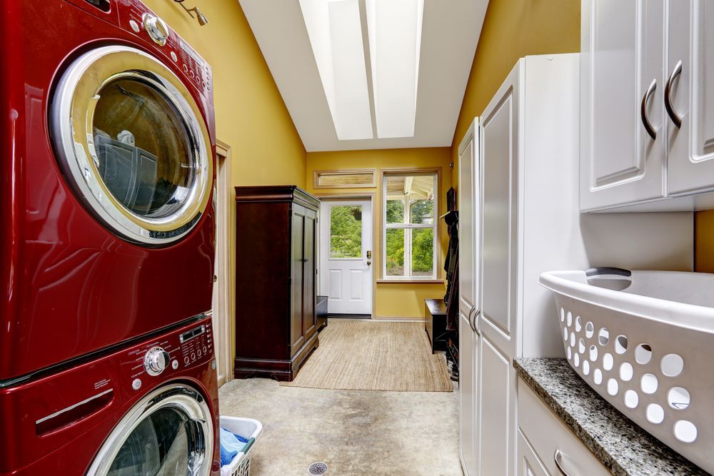 A Laundry Room With a Red Washer and Dryer Stacked on Top of Each Other — Hunter Kitchen King In Cessnock, NSW