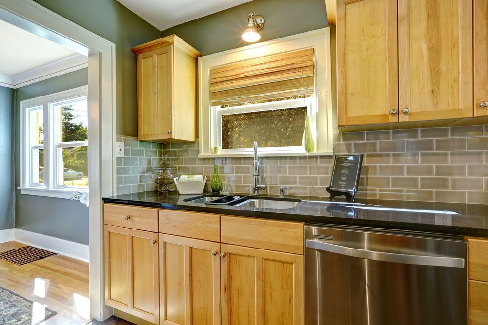 A Kitchen With Wooden Cabinets and a Window — Hunter Kitchen King in Merewether, NSW