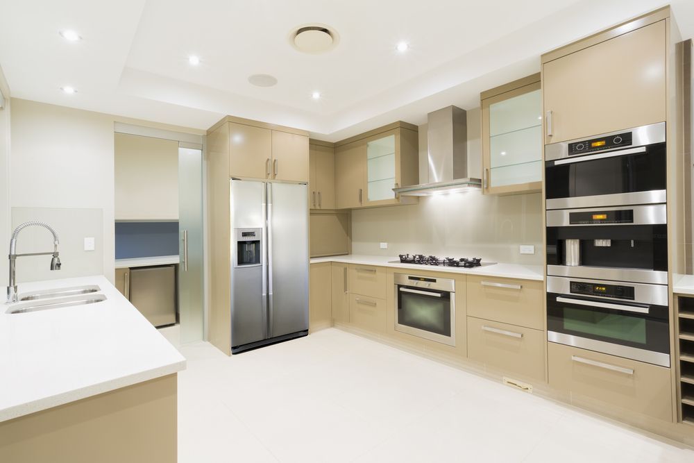 A Kitchen With Stainless Steel Appliances and Wooden Cabinets — Hunter Kitchen King In Raymond Terrace, NSW
