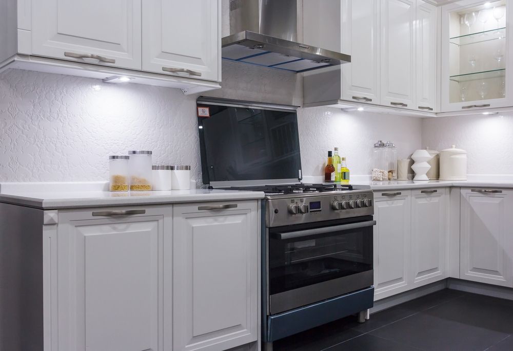 A Kitchen With White Cabinets and a Stove — Hunter Kitchen King In East Maitland, NSW