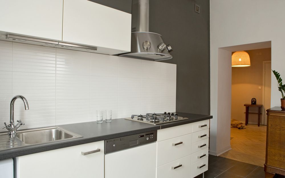 A Kitchen With White Cabinets and a Stove Top Oven — Hunter Kitchen King In East Maitland, NSW