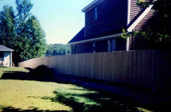 A house with a wooden fence in front of it