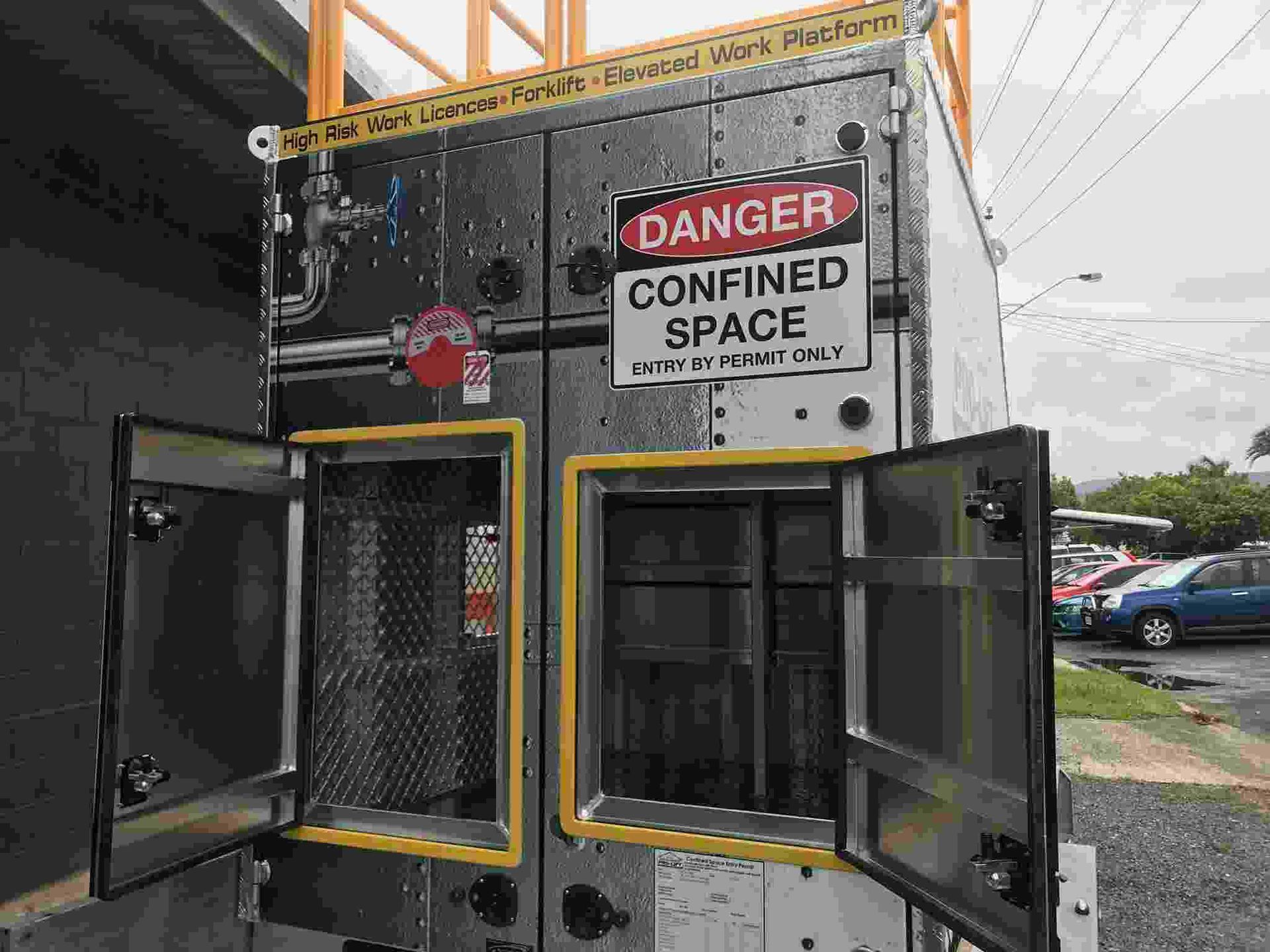 A Danger Confined Space Sign is on the Side of a Building — Boyd's Fabrications In Portsmith, QLD 