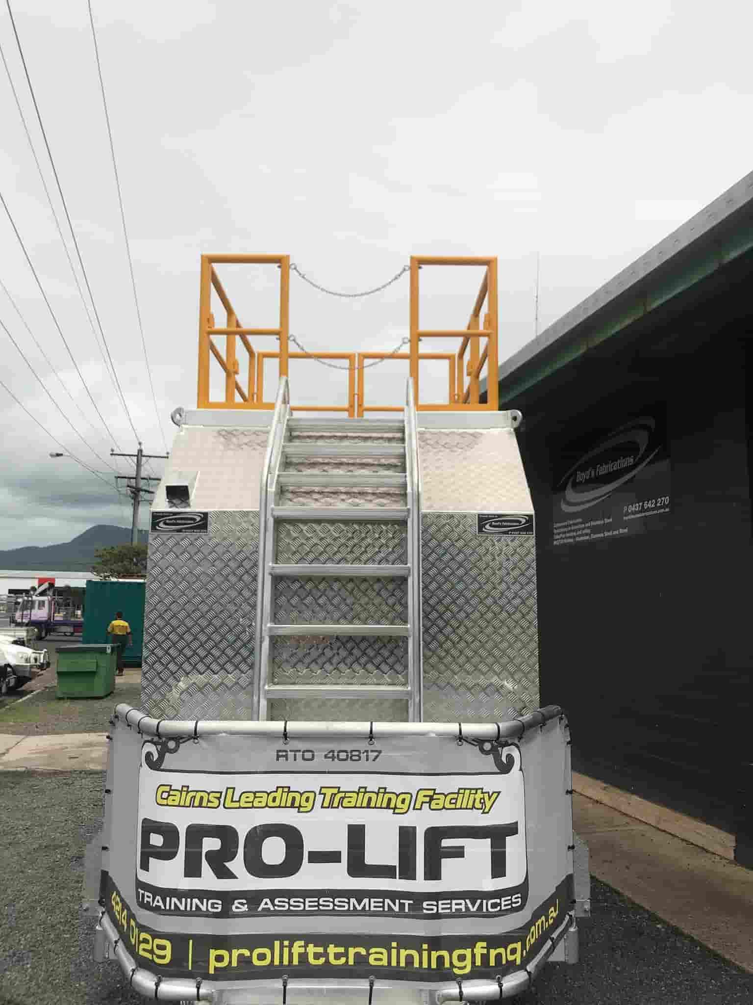 A Truck With a Ladder on the Back of It is Parked in Front of a Building — Boyd's Fabrications In Mt. Isa, QLD