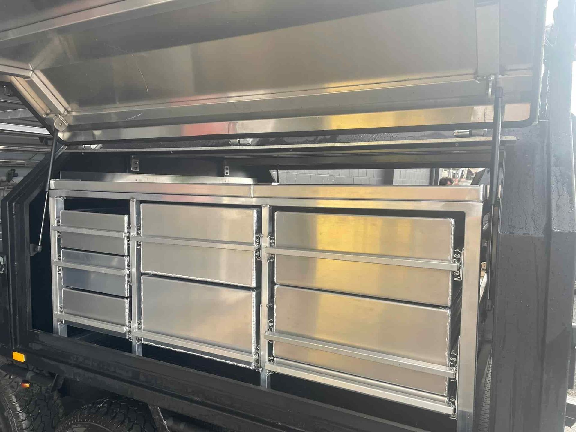A Stainless Steel Cabinet With Drawers Inside of a Truck — Boyd's Fabrications In Portsmith, QLD