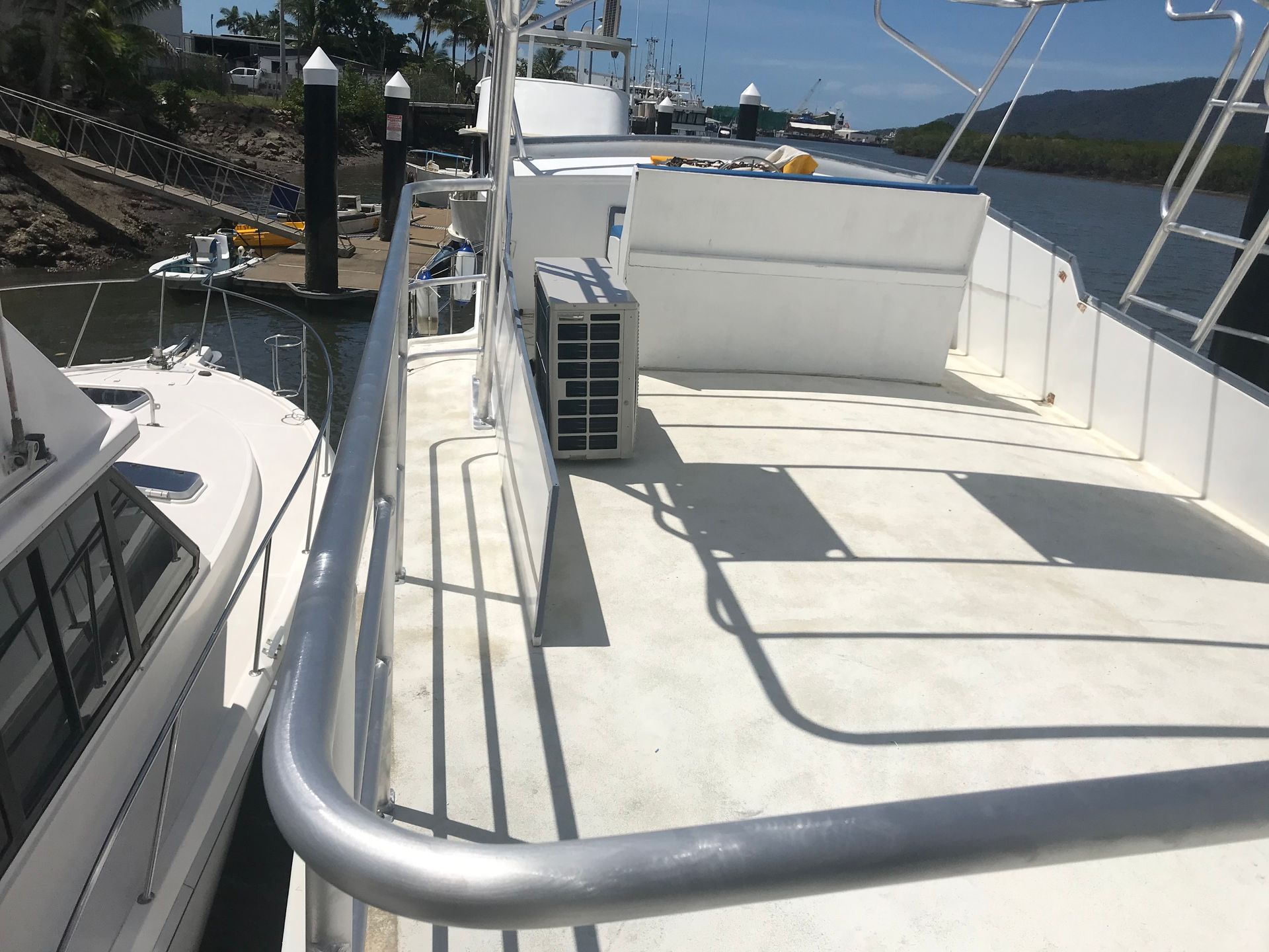 Boat deck with white paint, metal railings, and a gray air conditioning unit.— Boyd's Fabrications In Portsmith, QLD 