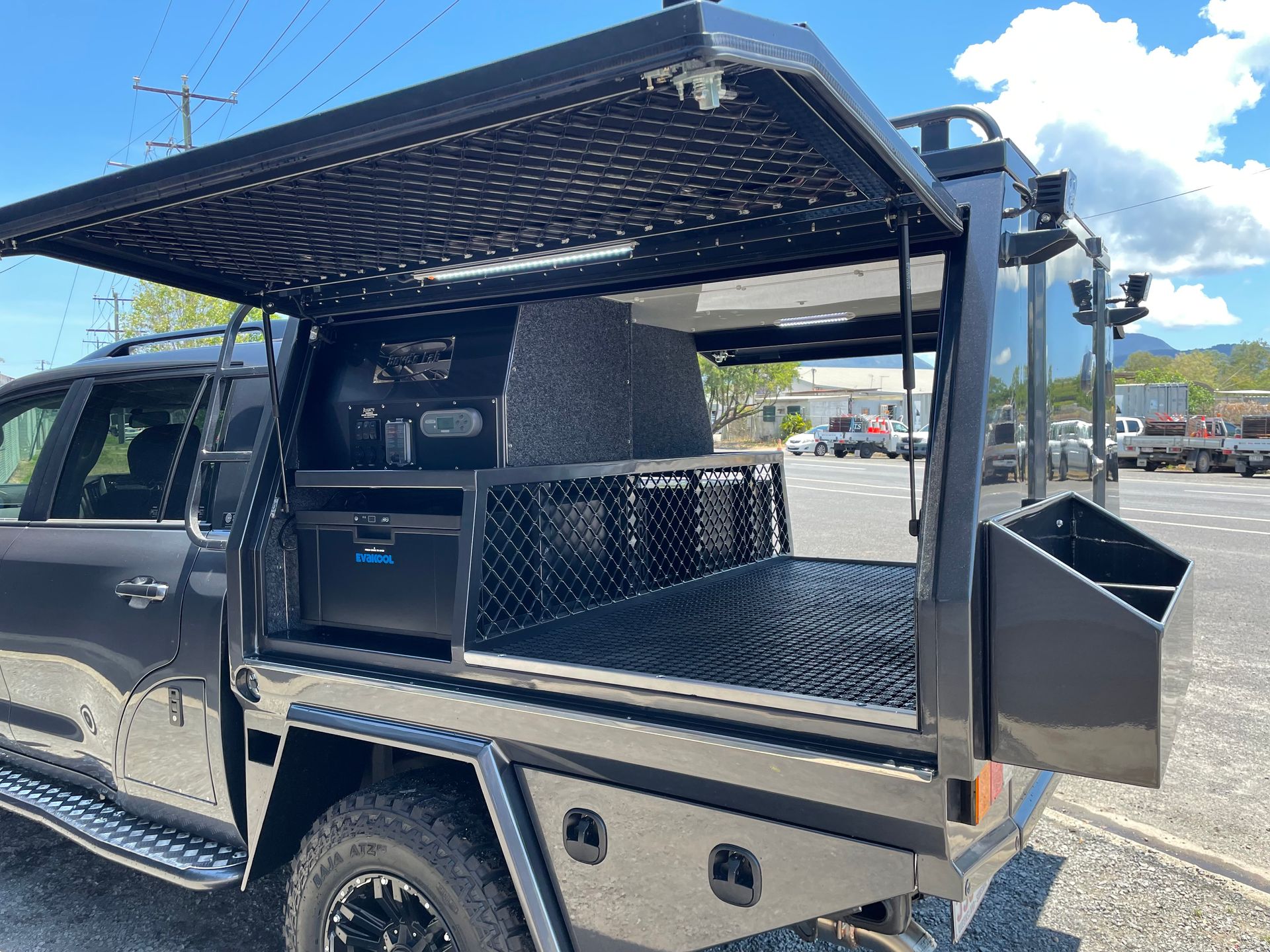 Black utility truck bed with canopy open, featuring storage, lighting, and diamond plate flooring.— Boyd's Fabrications In Portsmith, QLD 