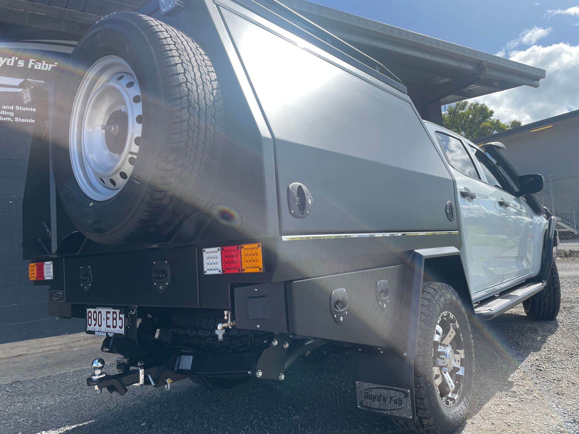 A light green utility truck with a dark grey canopy and spare tire attached.— Boyd's Fabrications In Portsmith, QLD 