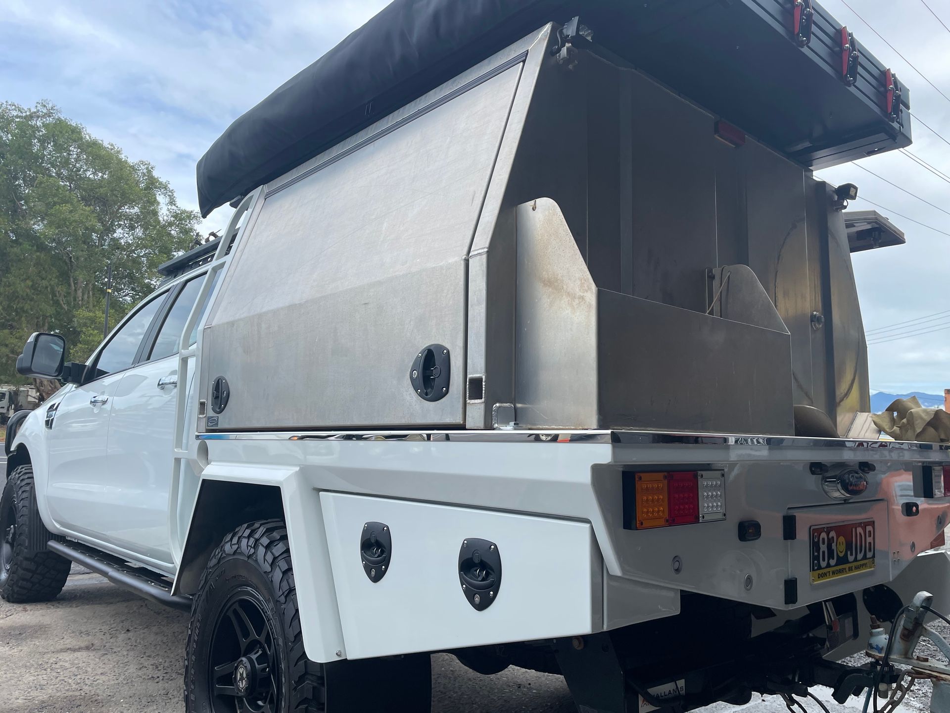 White pickup truck with a custom metal camper shell, parked outdoors.— Boyd's Fabrications In Portsmith, QLD 