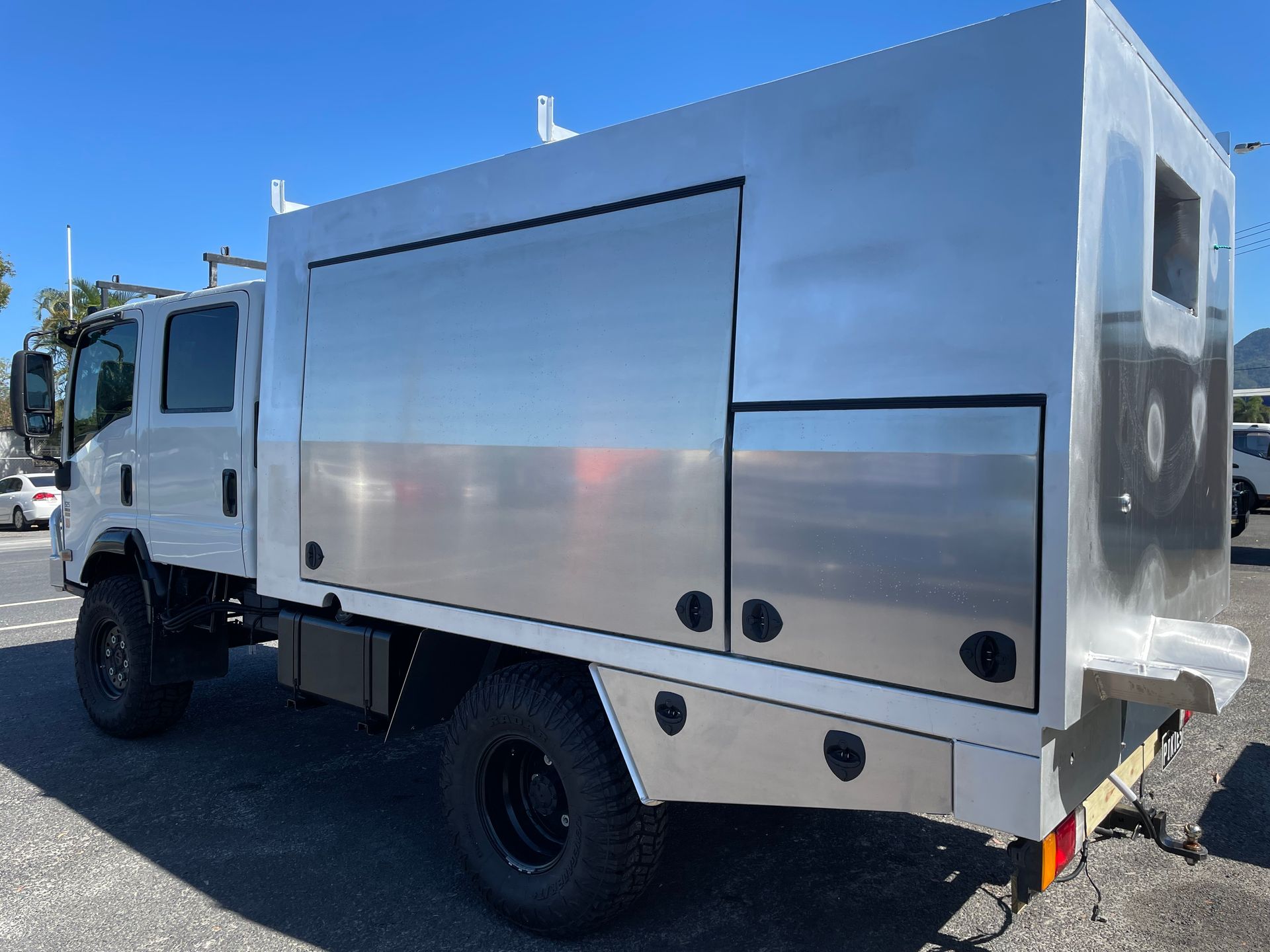 White service truck with silver storage compartments parked outdoors on a sunny day.— Boyd's Fabrications In Portsmith, QLD 