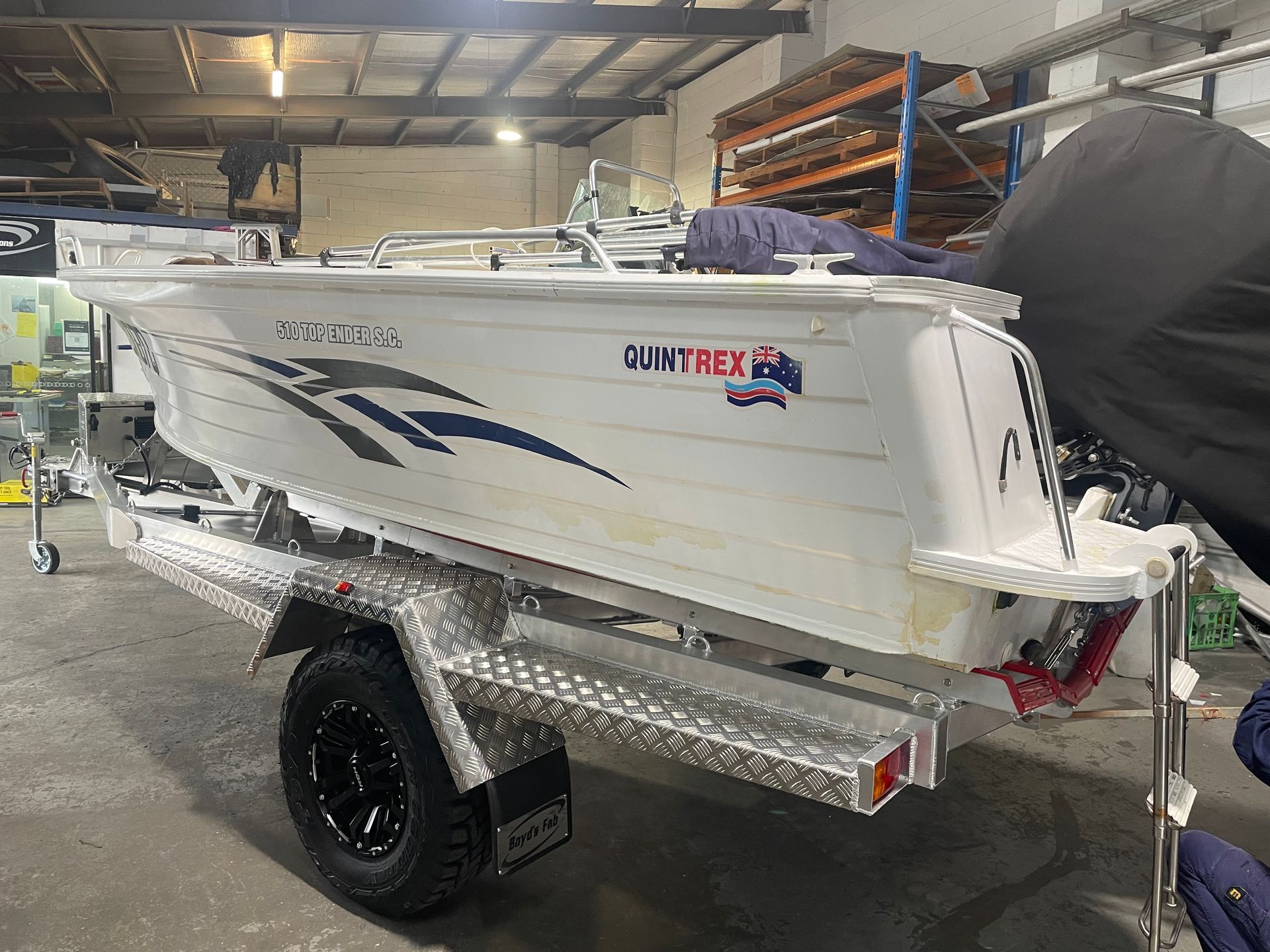 White aluminum boat on a trailer, with 