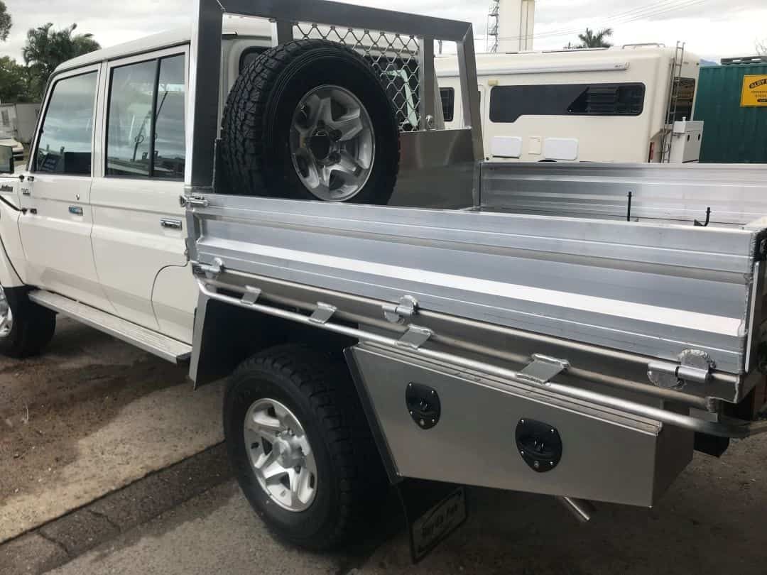 A White Truck With a Tray on the Back is Parked in a Parking Lot — Boyd's Fabrications In Gordonvale, QLD