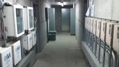 A long hallway with a lot of boxes on the wall.