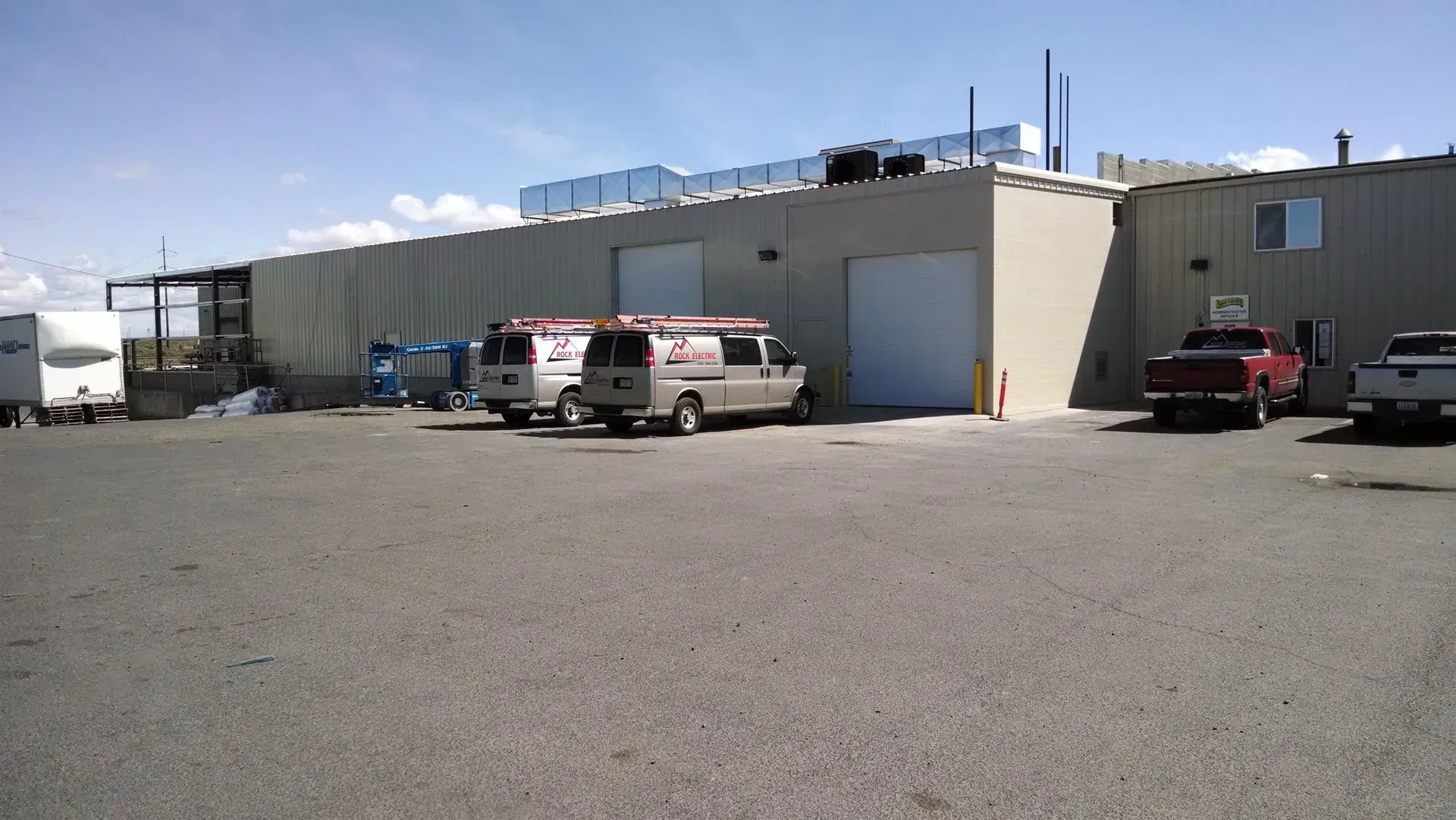 A row of vans are parked in front of a building