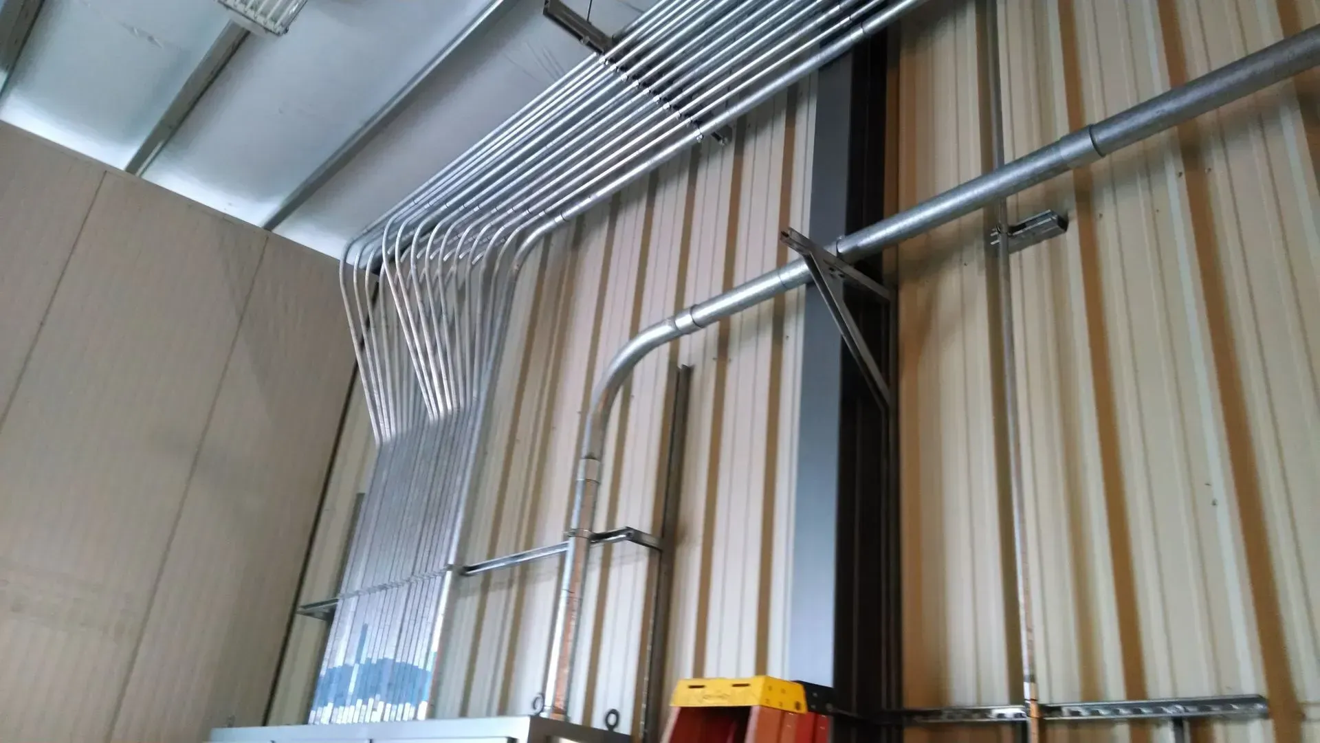 A ladder is hanging from the ceiling of a building.