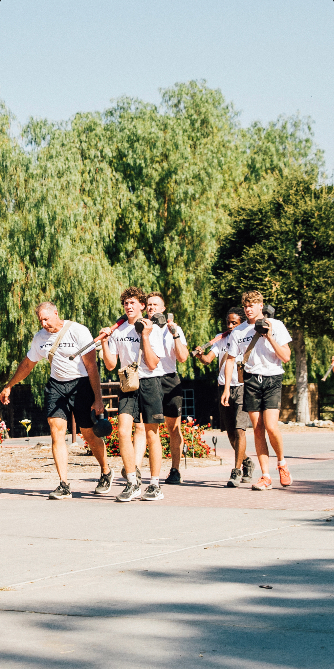 A group of people are walking down a street.