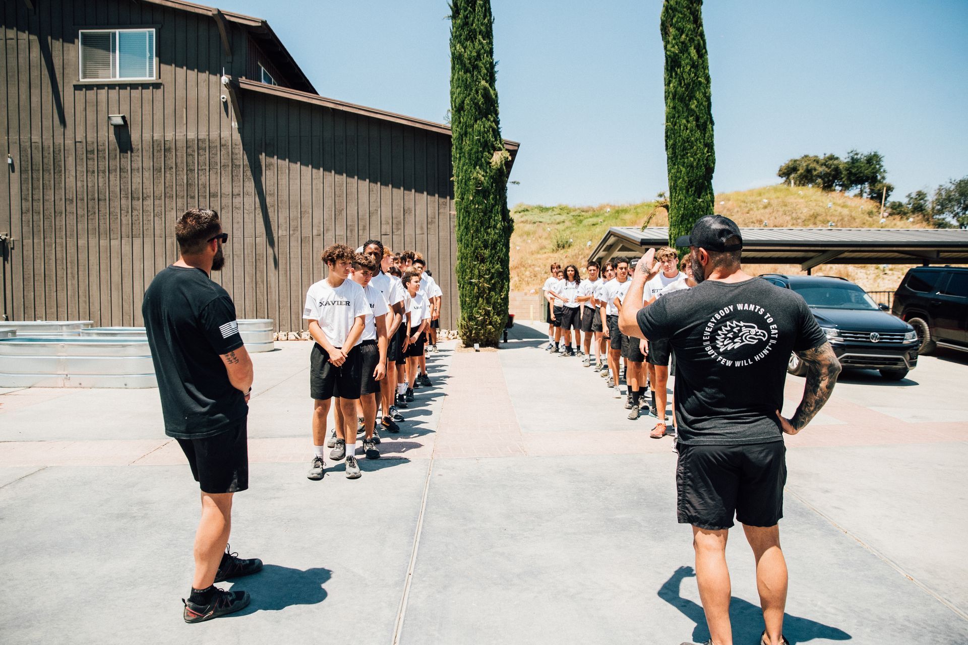 A group of people are standing in a line in front of a building.