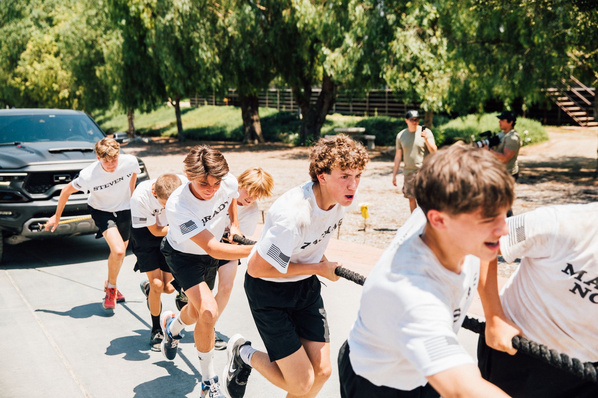 A group of young men pulling on a rope