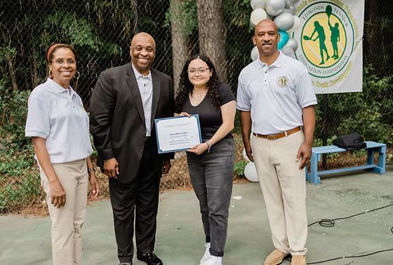 A group of people are standing next to each other on a tennis court.