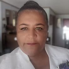 A close up of a woman 's face wearing a white jacket.