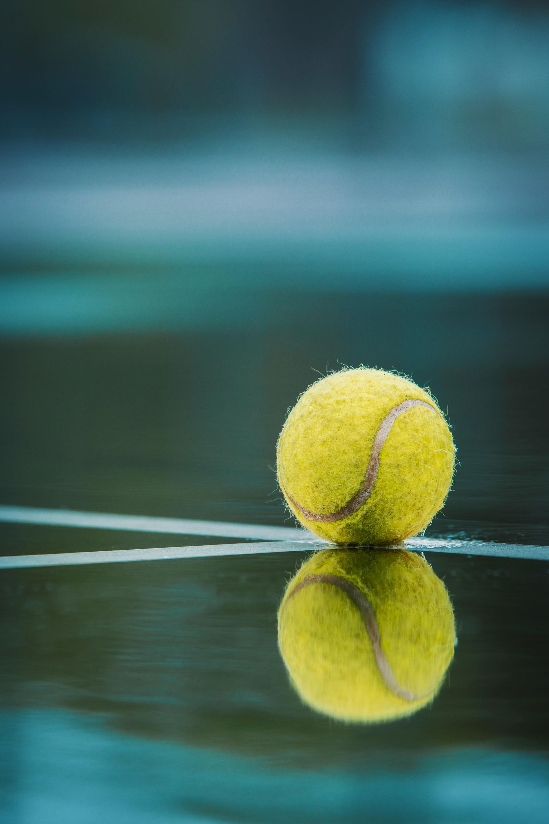 A close up of a tennis ball on a tennis court.