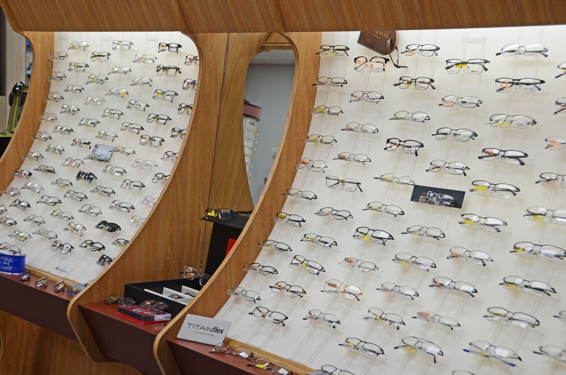 A man is trying on glasses in an optical shop.