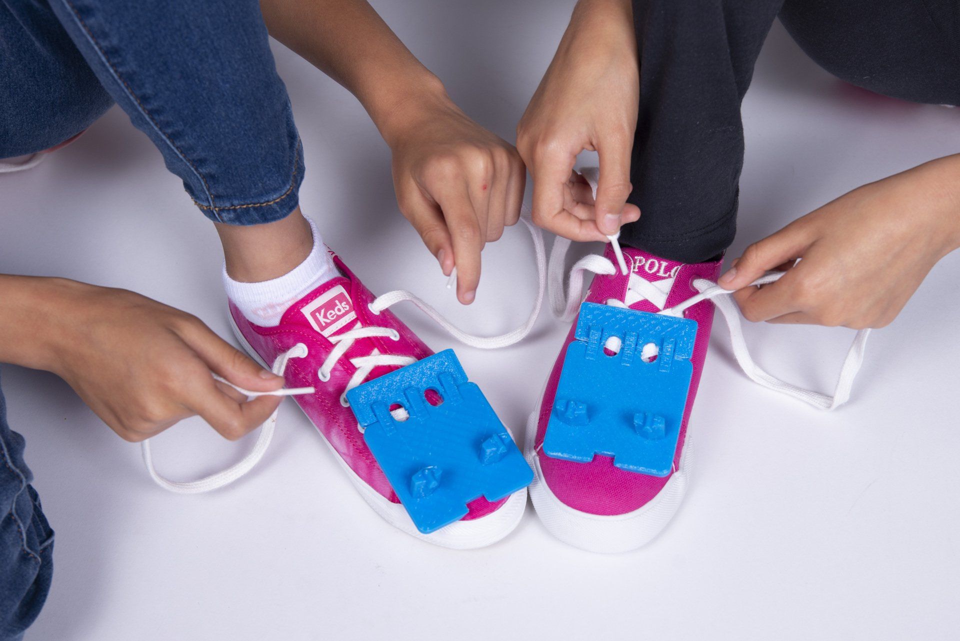 A group of children are tying their shoes together.