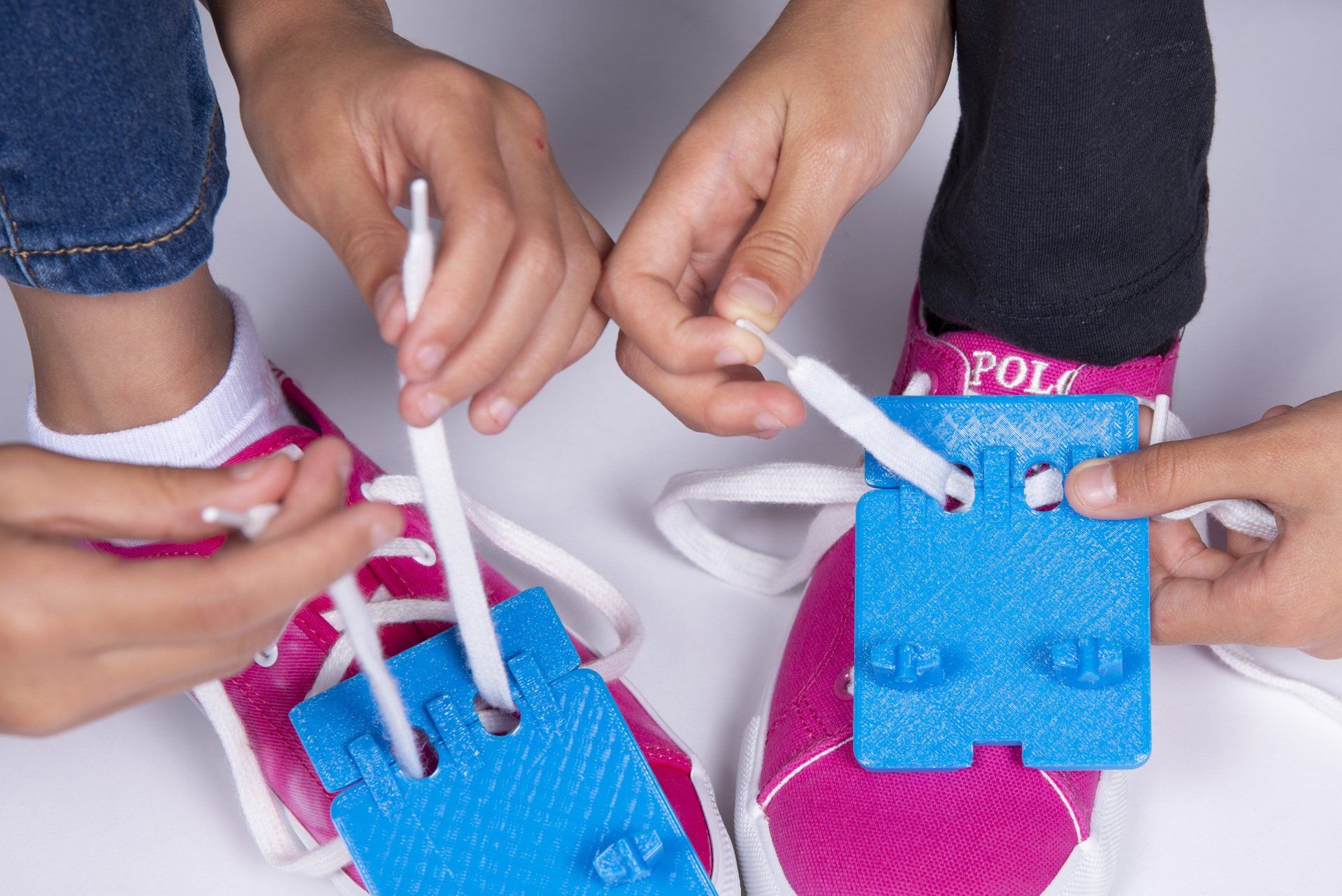 A group of children are tying their shoes together.