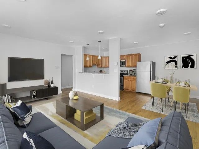 Waltham Overlook features renovated apartments with a living room overlooking the kitchen and dining area.