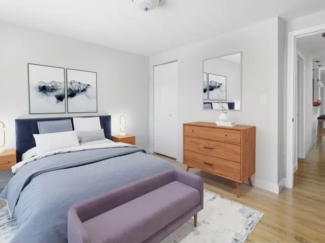 Waltham Overlook apartment bedroom with bed, wall art, rug, and dresser in Waltham, MA.