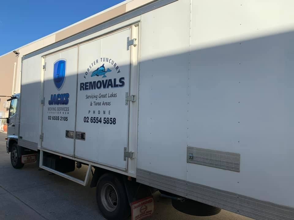 A White Removals Truck is Parked in Front of a Building — Forster Tuncurry Removals & Storage In Tuncurry, NSW