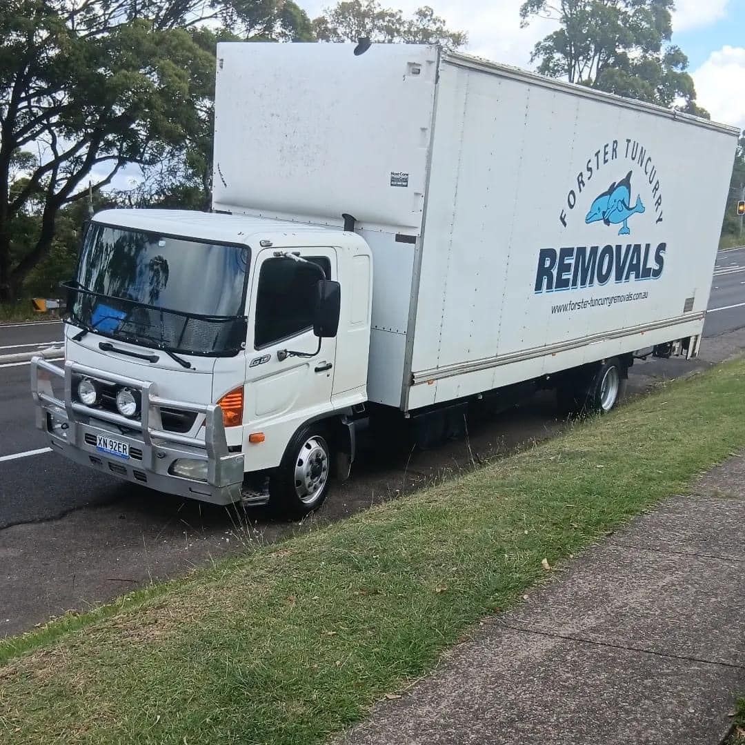A White Truck Is Driving On A Bridge Over A Body Of Water — Forster Tuncurry Removals & Storage In Forster, NSW