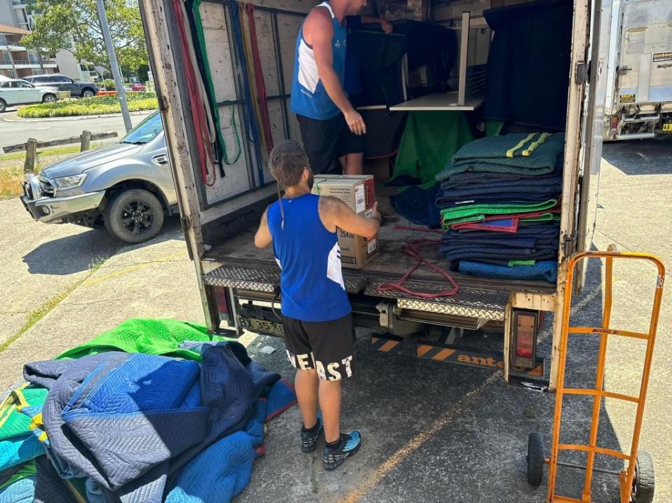 Two Men Loading a Truck With Furniture — Forster Tuncurry Removals & Storage in Forster, NSW