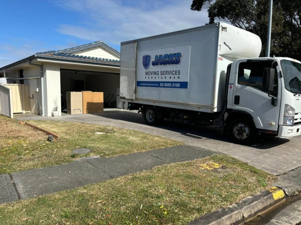 Moving Truck Parked in Front of a House — Forster Tuncurry Removals & Storage in Central Coast, NSW
