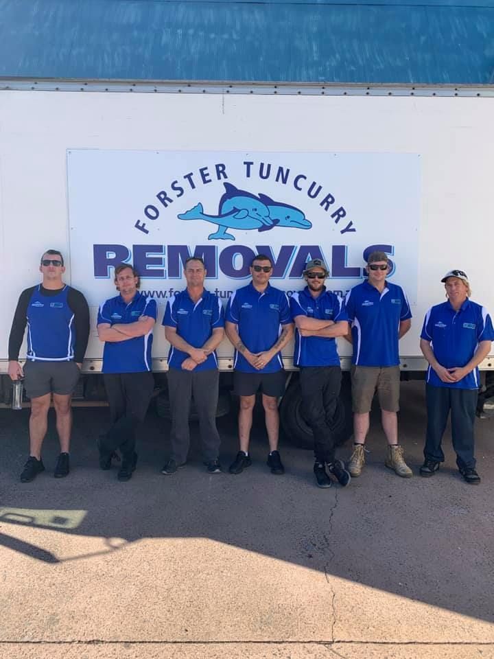 Group of People in Blue Uniforms Stand in Beside the Truck — Forster Tuncurry Removals & Storage in Newcastle, NSW