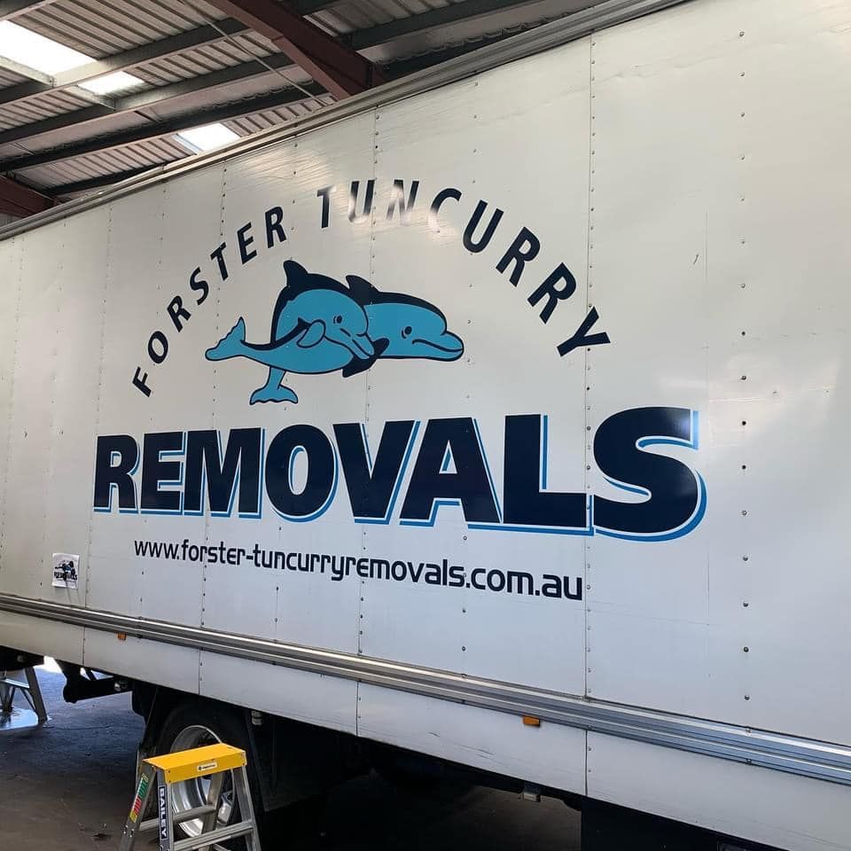 A Forster Curry Removals Truck is Parked in a Garage — Forster Tuncurry Removals & Storage in Tuncurry, NSW
