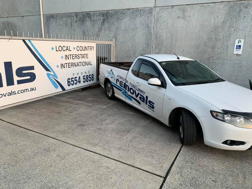 A White Truck Is Parked Next To A Sign That Says Removals — Forster Tuncurry Removals & Storage In Tuncurry, NSW 