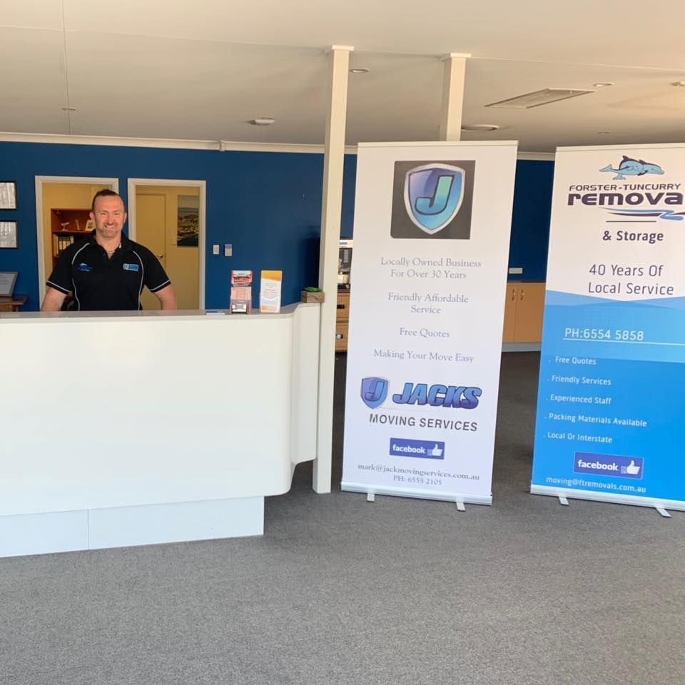 A Man Standing Behind a Counter at a Moving Company — Forster Tuncurry Removals & Storage in Tuncurry, NSW