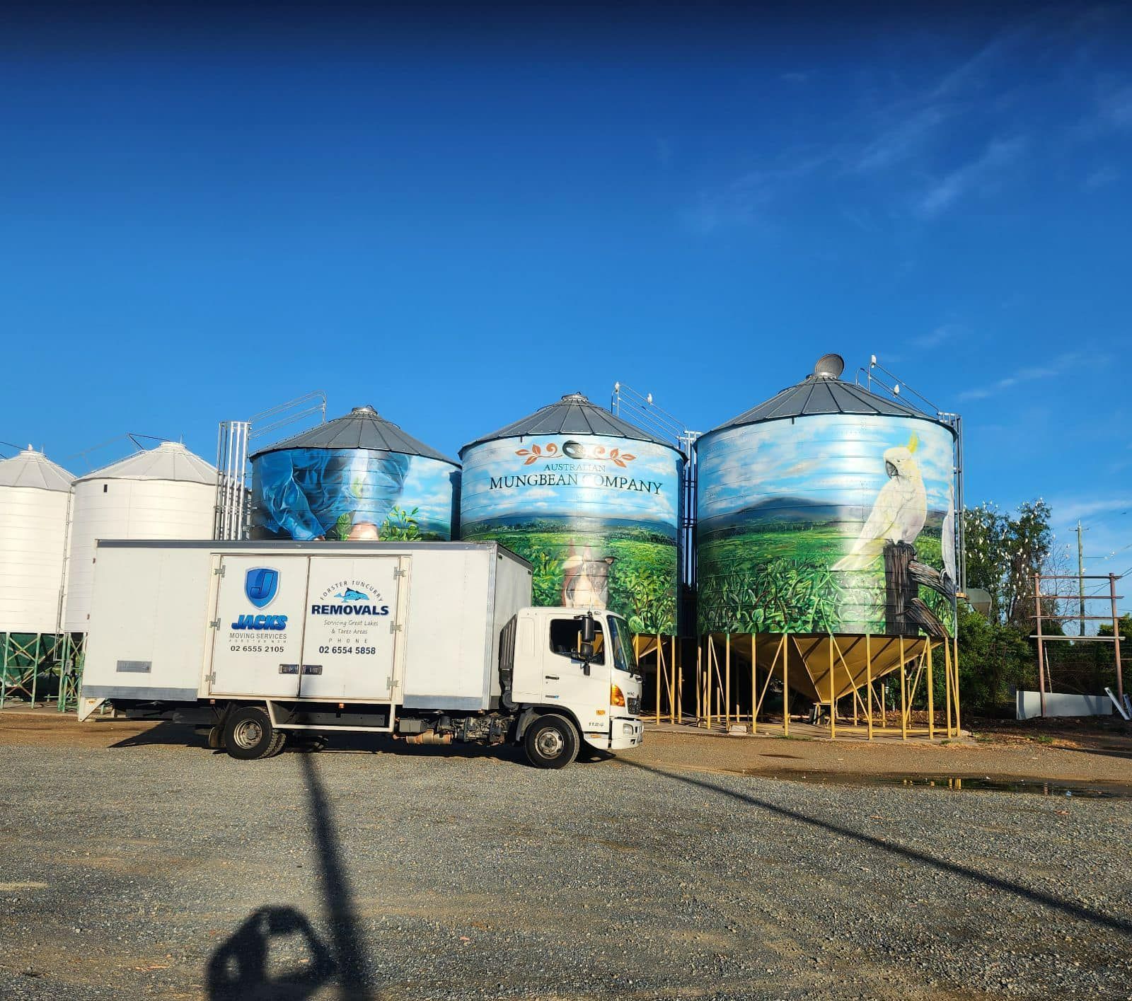 A Truck is Parked in Front of a Row of Silos — Forster Tuncurry Removals & Storage in Tuncurry, NSW