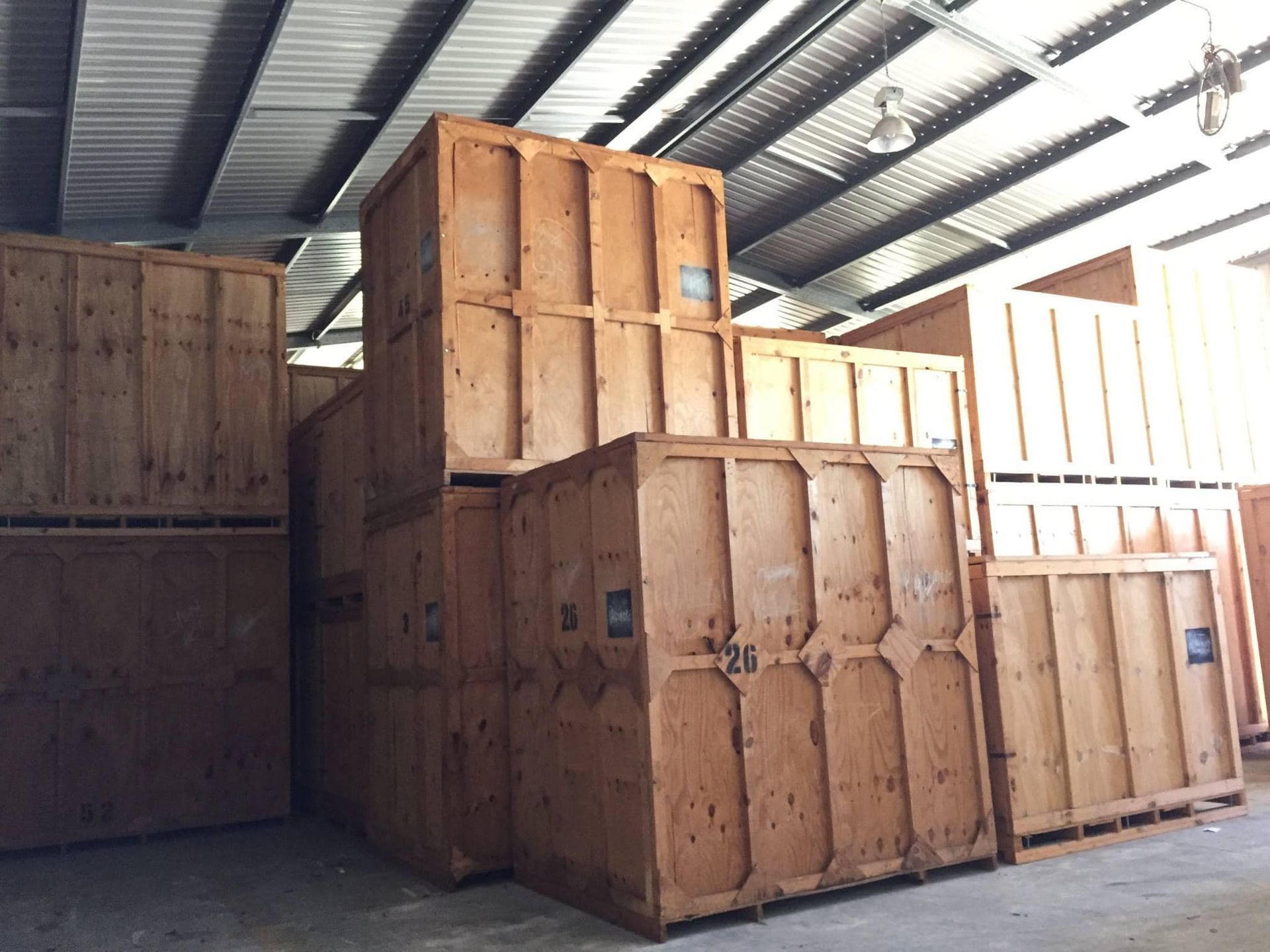 Warehouse Filled With Lots of Wooden Crates Stacked on Each Other — Forster Tuncurry Removals & Storage in Tuncurry, NSW