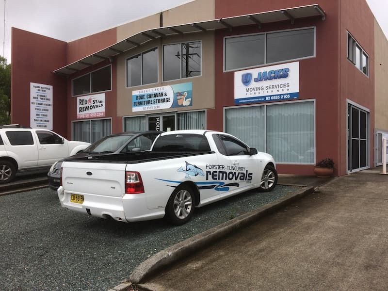 A White Truck is Parked in Front of a Building — Forster Tuncurry Removals & Storage in Tuncurry, NSW