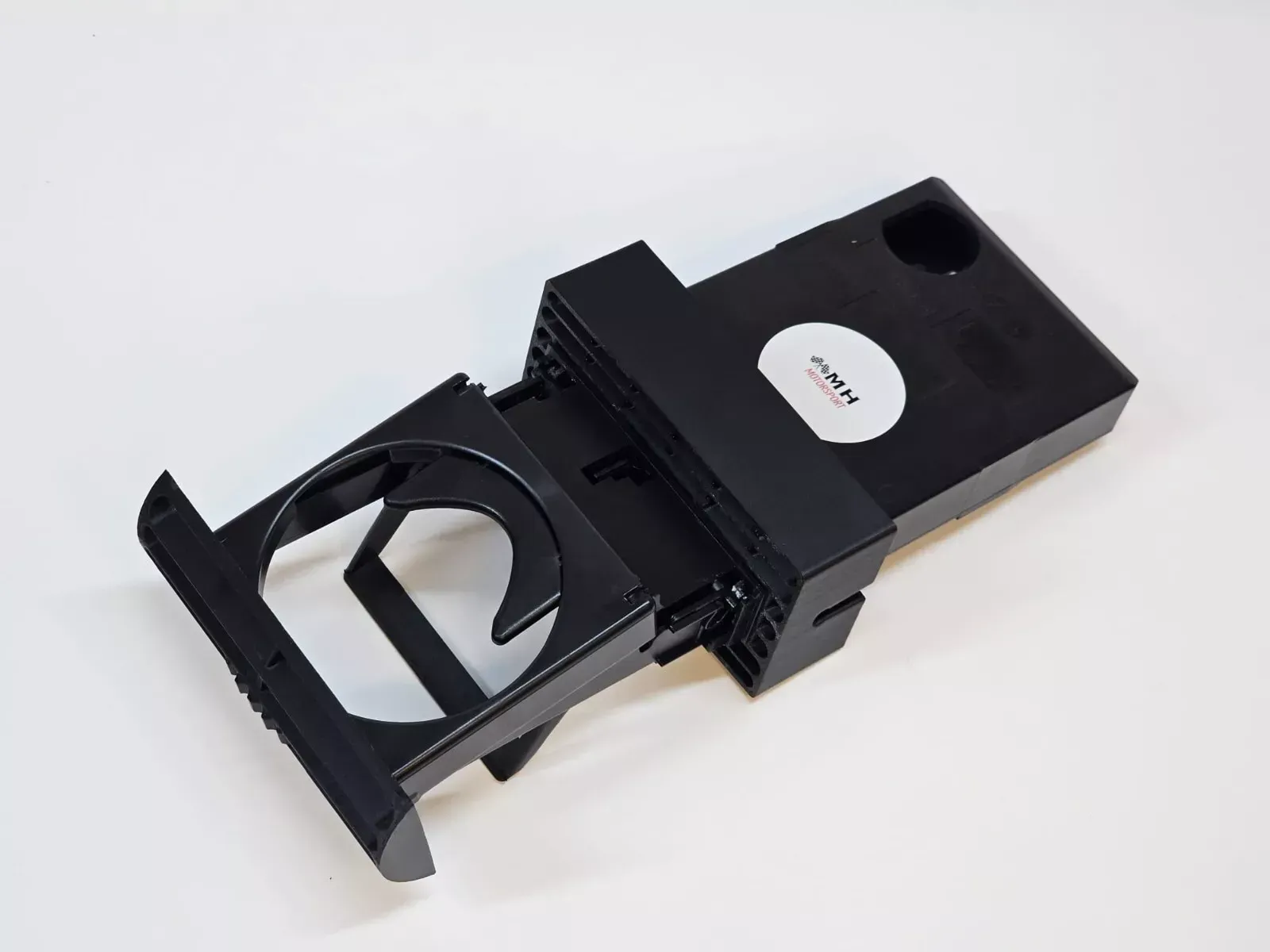 Black car console cup holder, extended.