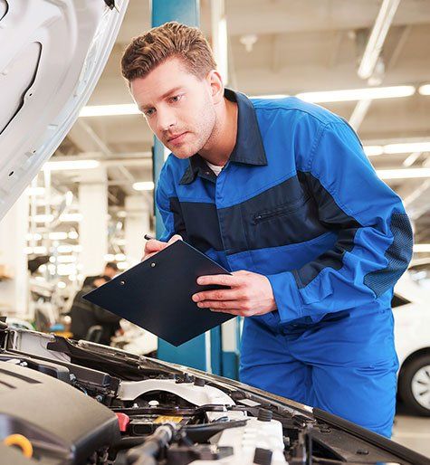 Auto Repair — Mechanic Checking the Engine in Hayden, ID