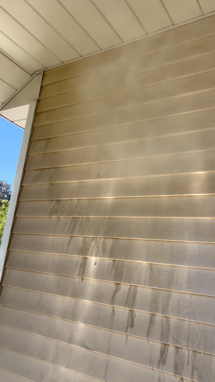A close up of a siding on a house with a window.