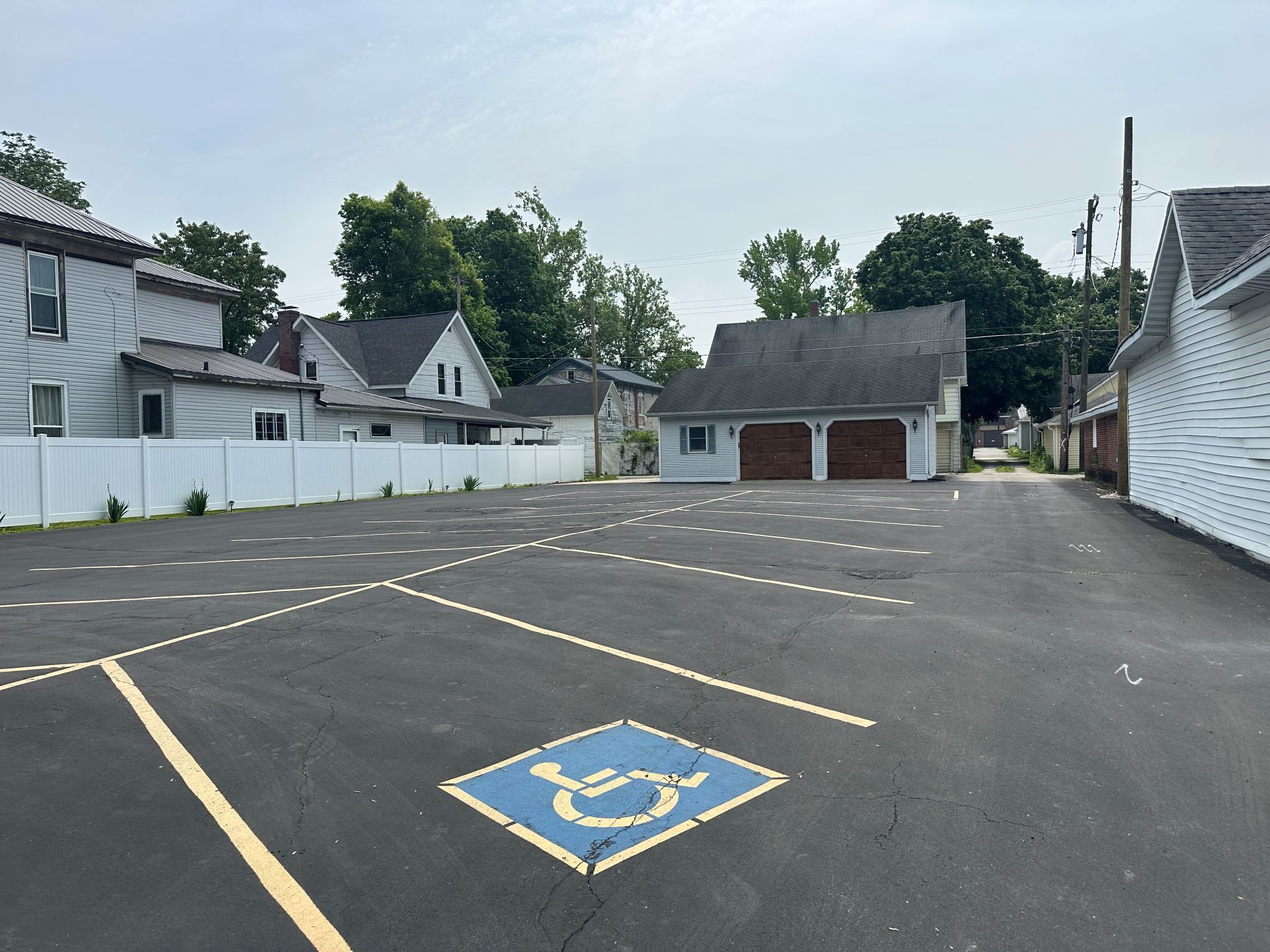 A parking lot with a handicap sign in the middle