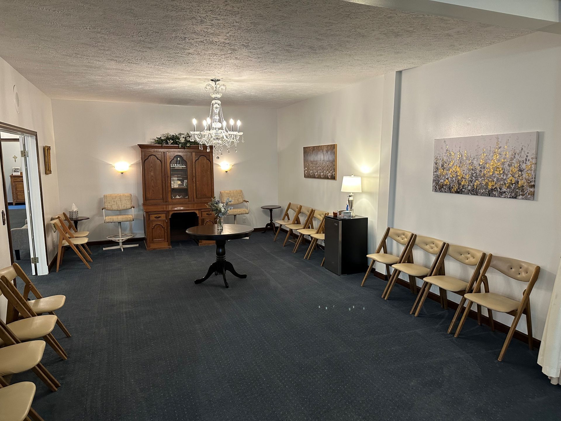 There is a table and chairs in the middle of the room.